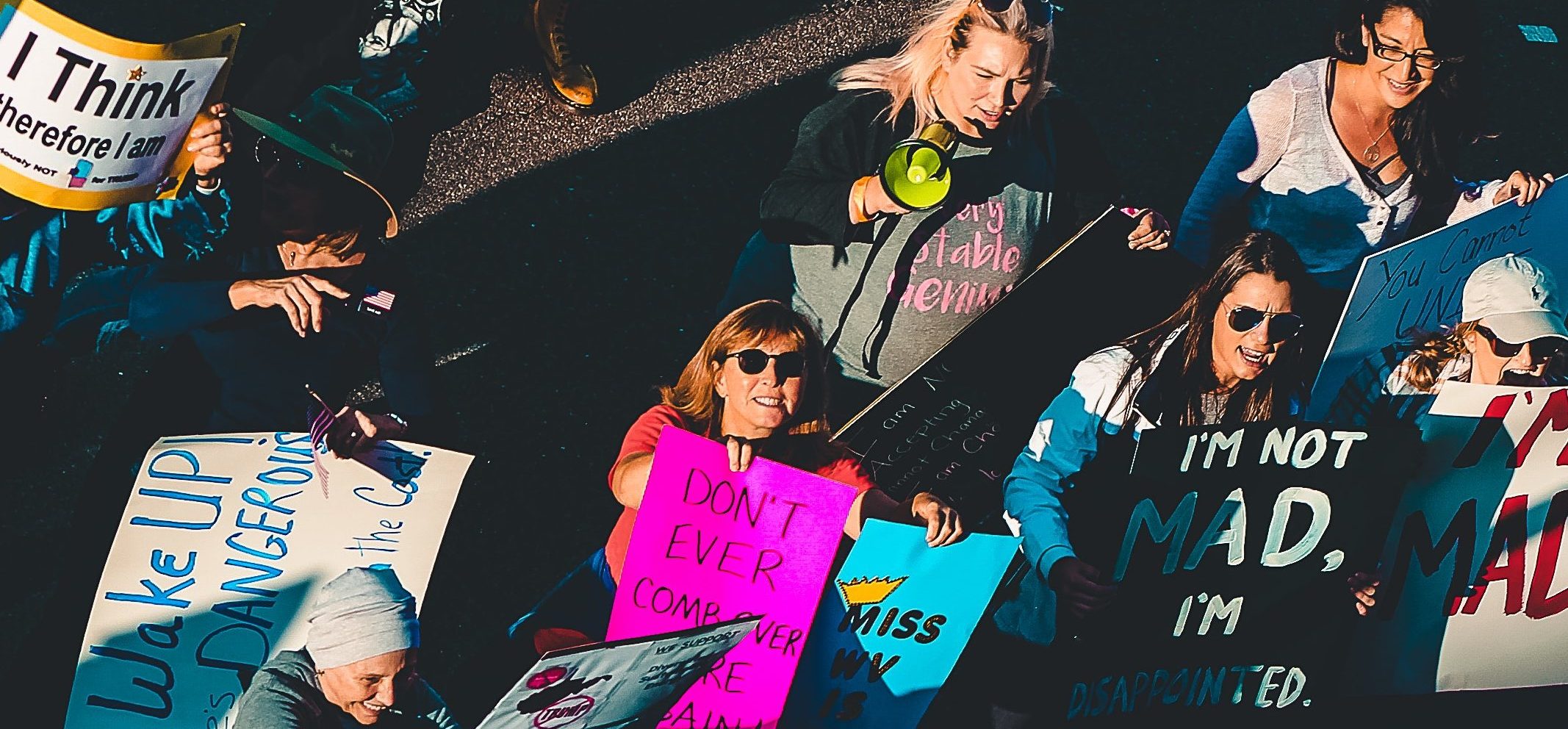 people-standing-with-signage-on-street-1464232