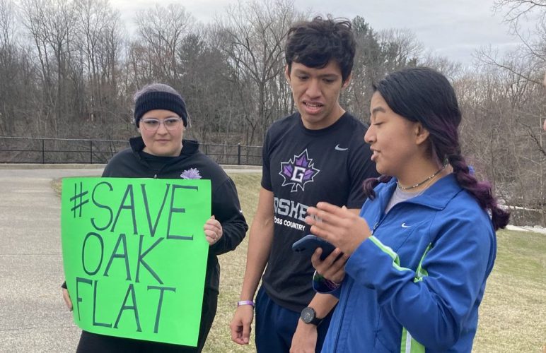 Arleth Martinez (right) and Manny Villanueva (center) shared a recording of an Apache prayer song with the group gathered in Goshen, Indiana on Tuesday. Arleth and Manny are the leaders of the One Circle club at Goshen College which works with the Dismantling the Doctrine of Discovery Coalition to advocate for indigenous justice. Photo by Jane Ross Richer.